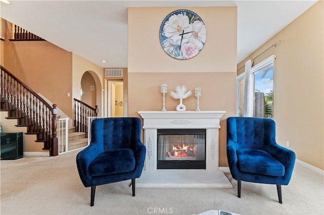16720 S Peak Ct, Riverside, CA 92503 - sitting room featuring carpet, a glass covered fireplace, stairway, and arched walkways