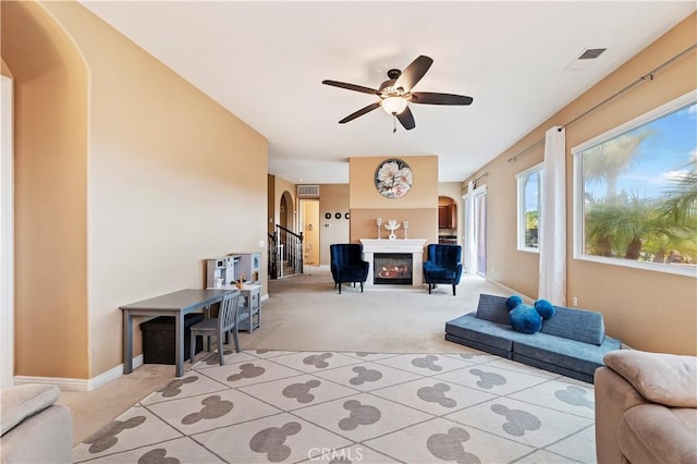 16720 S Peak Ct, Riverside, CA 92503 - living area featuring light colored carpet, arched walkways, a ceiling fan, and a glass covered fireplace