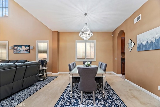 16720 S Peak Ct, Riverside, CA 92503 - dining room featuring arched walkways, light colored carpet, and a chandelier