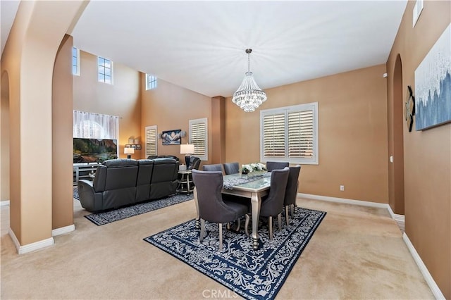 16720 S Peak Ct, Riverside, CA 92503 - dining area with carpet floors, arched walkways, and a chandelier