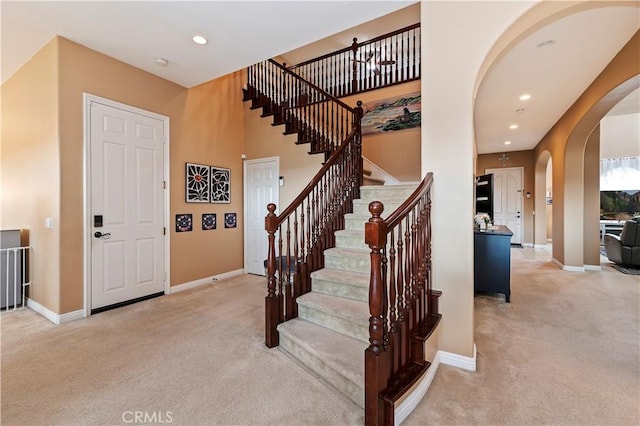 16720 S Peak Ct, Riverside, CA 92503 - entryway featuring carpet flooring, arched walkways, stairway, and recessed lighting
