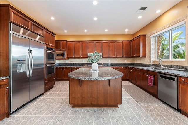 16720 S Peak Ct, Riverside, CA 92503 - kitchen featuring built in appliances, dark stone counters, a kitchen island, under cabinet range hood, and backsplash