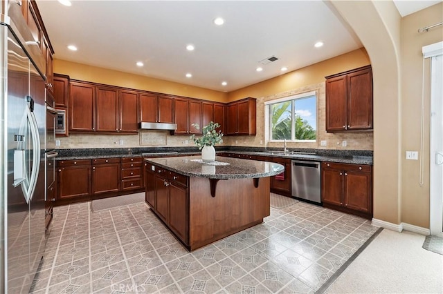 16720 S Peak Ct, Riverside, CA 92503 - kitchen with stainless steel appliances, a kitchen island, under cabinet range hood, decorative backsplash, and recessed lighting