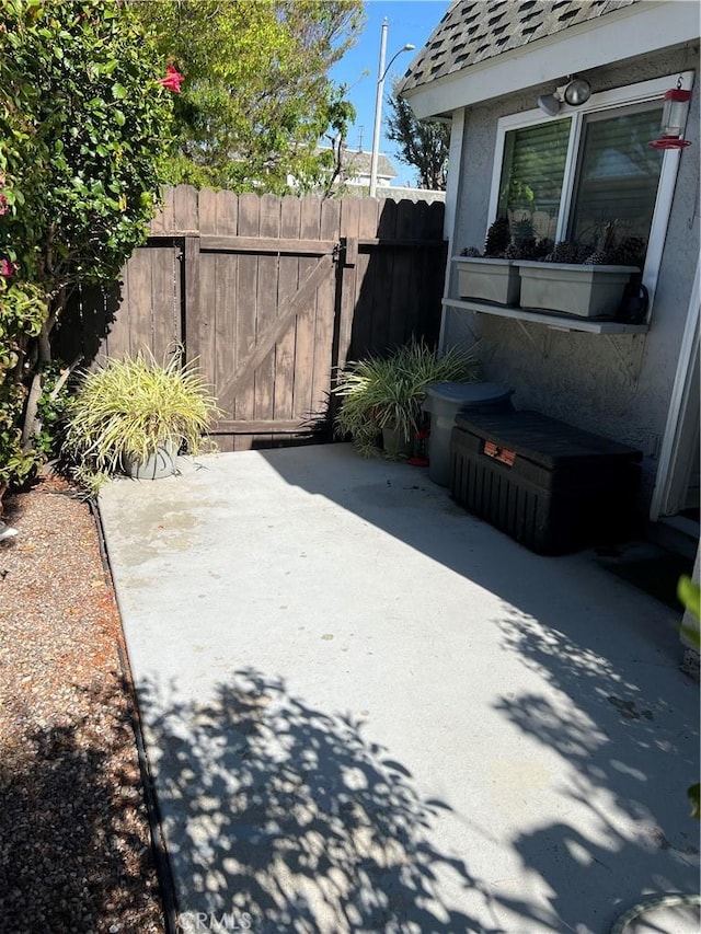 view of patio featuring a gate and fence