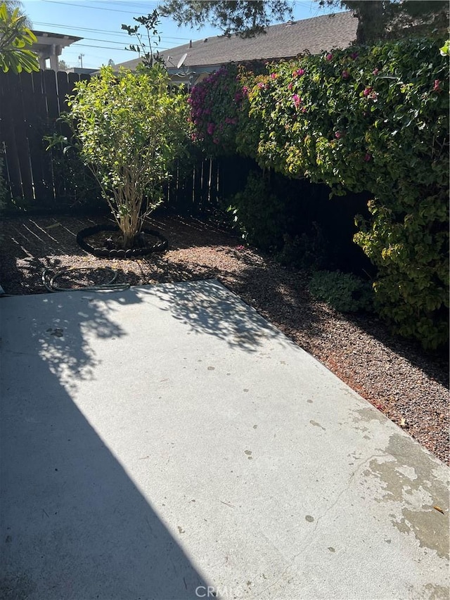 view of yard with fence and a patio