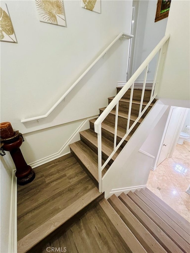 stairway with wood finished floors