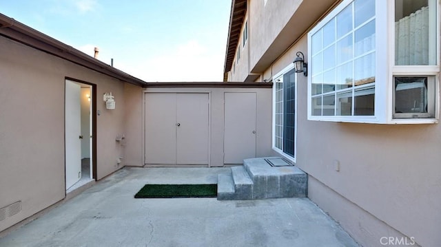 view of patio / terrace featuring a storage shed
