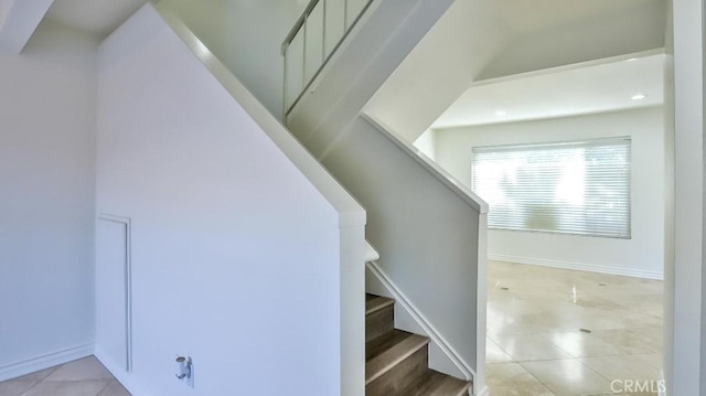 staircase featuring tile patterned floors