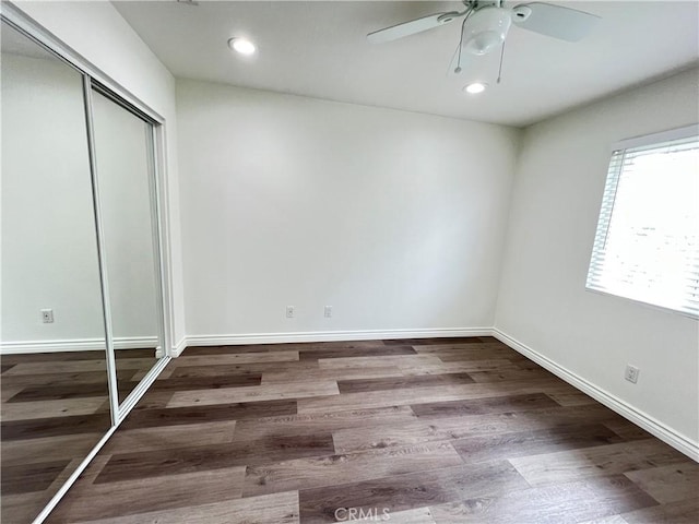 unfurnished bedroom with a closet, recessed lighting, and wood finished floors