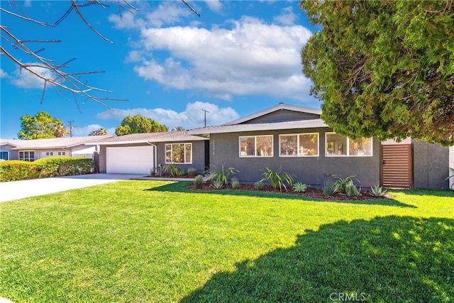 ranch-style home featuring concrete driveway, a front lawn, an attached garage, and stucco siding