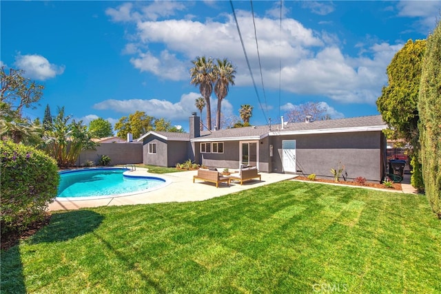 rear view of house with outdoor lounge area, a lawn, stucco siding, and a fenced backyard