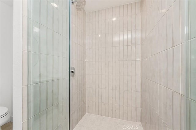 full bathroom with toilet and tiled shower
