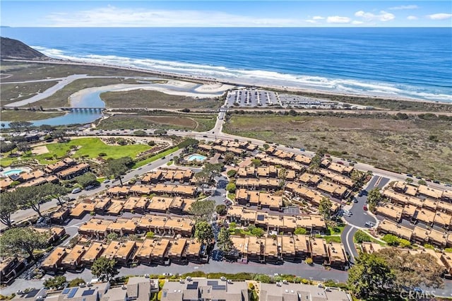 drone / aerial view with a beach view and a water view