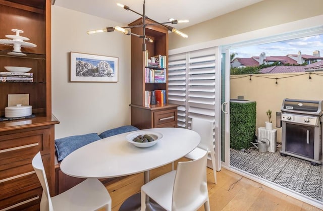 7031 Estrella De Mar Rd, Carlsbad, CA 92009 - dining area with light wood-style floors and a chandelier
