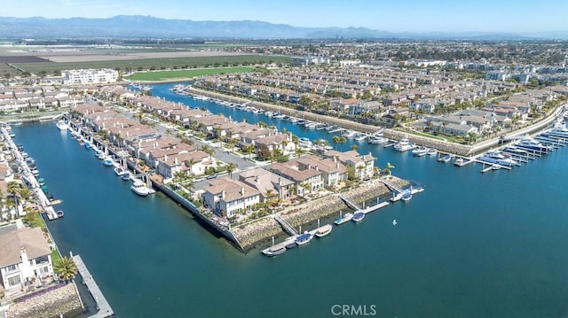 birds eye view of property with a water and mountain view