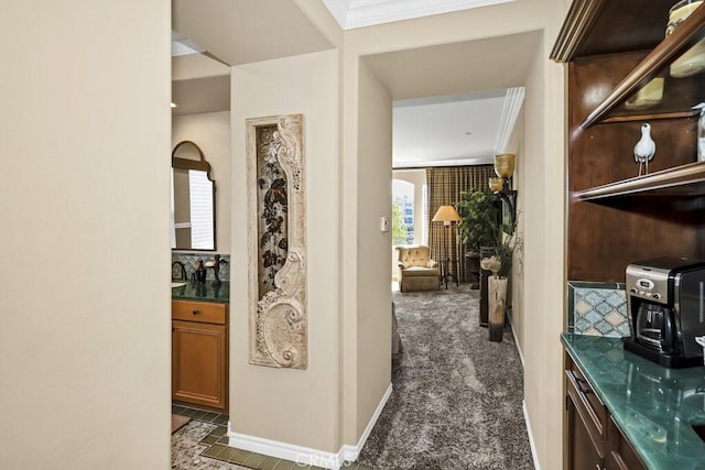 hall featuring carpet and ornamental molding