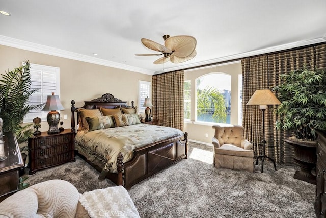 bedroom with crown molding, carpet flooring, baseboards, and ceiling fan