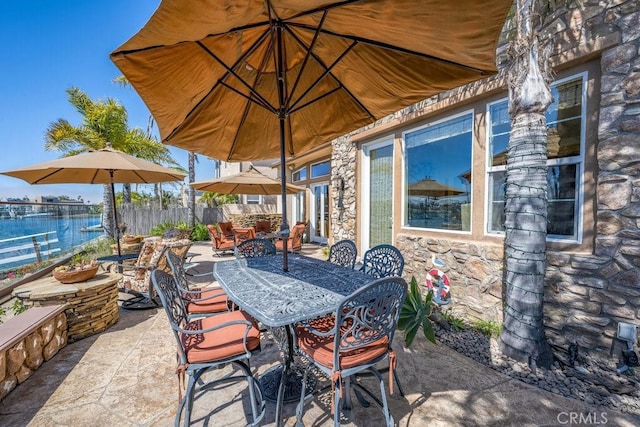 view of patio with fence and outdoor dining space
