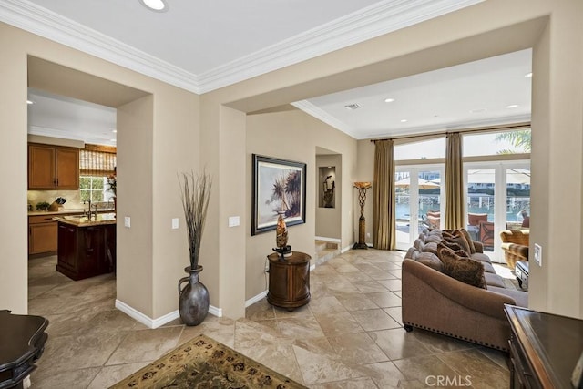 hall with baseboards, a sink, recessed lighting, and ornamental molding