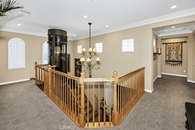 hall with an upstairs landing, a chandelier, carpet floors, baseboards, and visible vents