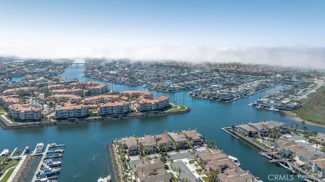 drone / aerial view featuring a water view and a residential view