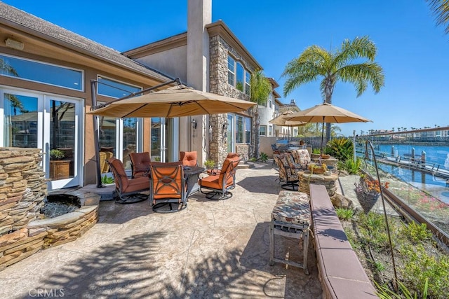 view of patio / terrace with outdoor dining space and a water view
