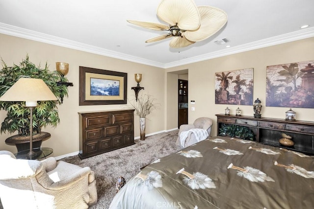 carpeted bedroom featuring baseboards, a ceiling fan, visible vents, and crown molding