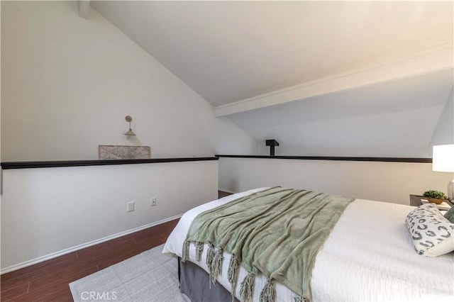 bedroom featuring baseboards, vaulted ceiling with beams, and wood finished floors