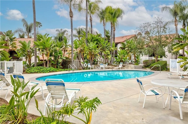 pool featuring a patio and fence