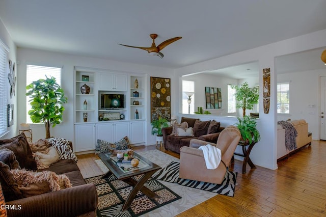 living room featuring light wood-style floors and ceiling fan