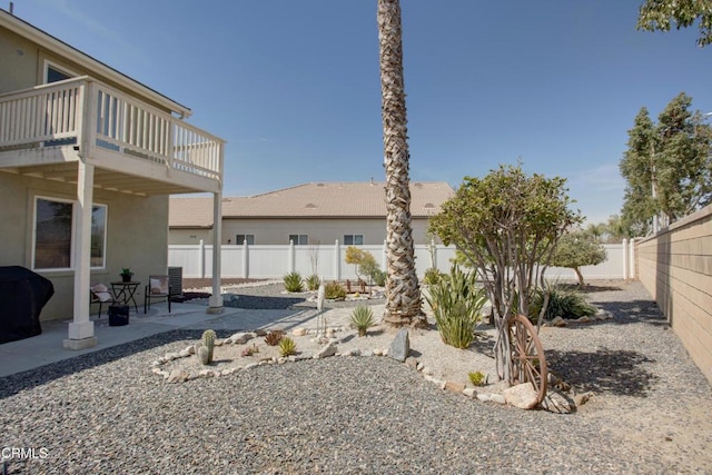 rear view of property with a balcony, central AC unit, a patio, a fenced backyard, and stucco siding