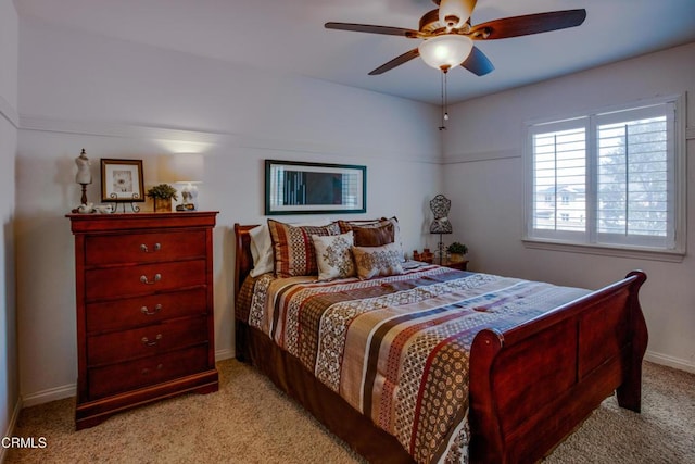 carpeted bedroom with a ceiling fan and baseboards