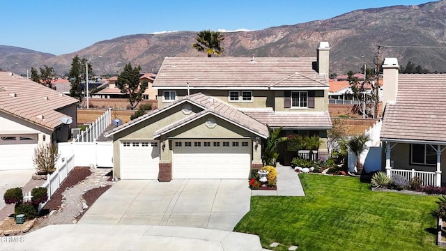 view of front of house with a tile roof, a front yard, driveway, and stucco siding