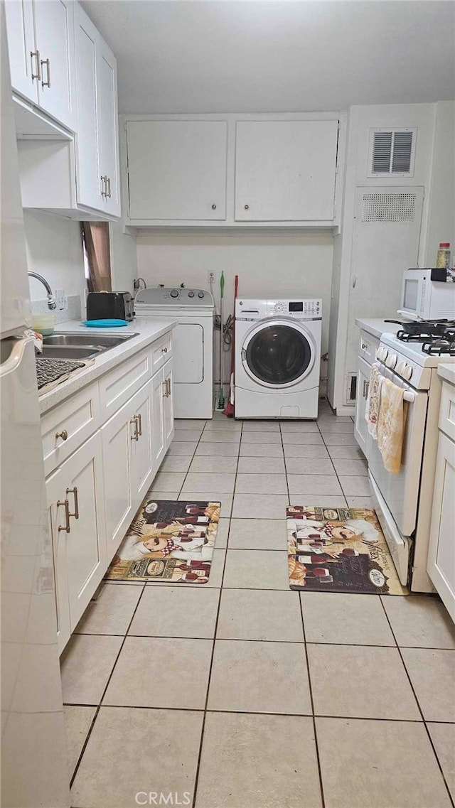 929 E Elizabeth St, Barstow, CA 92311 - clothes washing area with washer and clothes dryer, a sink, light tile patterned floors, laundry area, and visible vents