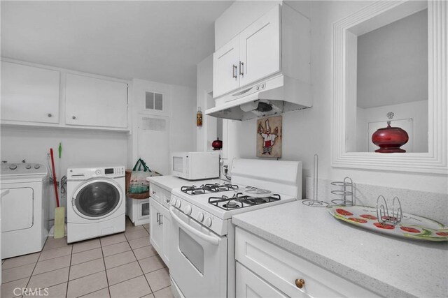 929 E Elizabeth St, Barstow, CA 92311 - kitchen with white appliances, washer and clothes dryer, under cabinet range hood, and white cabinetry