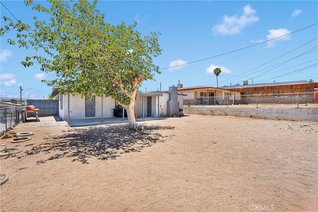 929 E Elizabeth St, Barstow, CA 92311 - rear view of house featuring a fenced backyard and stucco siding