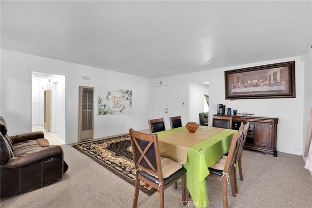 929 E Elizabeth St, Barstow, CA 92311 - dining area featuring light colored carpet
