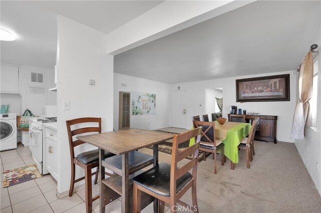 929 E Elizabeth St, Barstow, CA 92311 - dining room featuring washer / clothes dryer and light tile patterned floors
