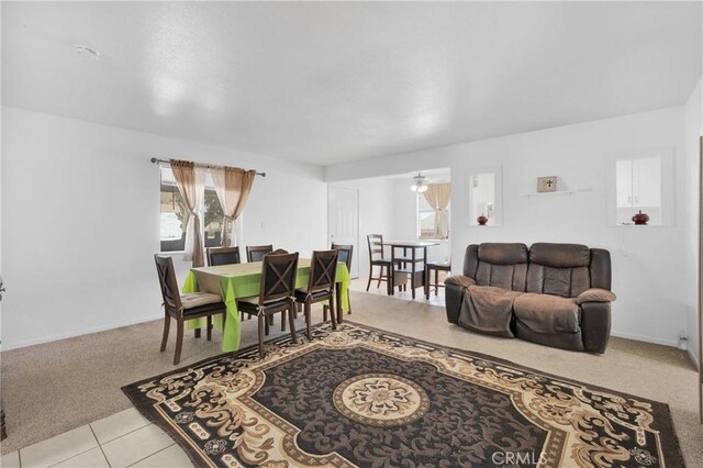 929 E Elizabeth St, Barstow, CA 92311 - dining area with light carpet, light tile patterned floors, and baseboards