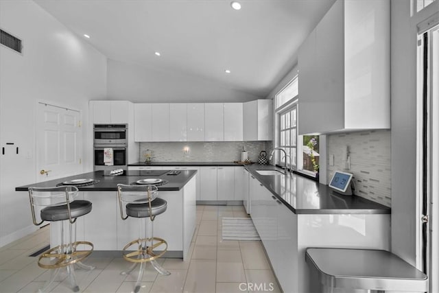 10 Stagecoach Rd, Bell Canyon, CA 91307 - kitchen with a sink, white cabinetry, stainless steel double oven, modern cabinets, and dark countertops