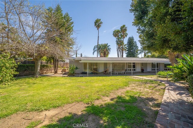 3540 Watkins Dr, Riverside, CA 92507 - rear view of property featuring a patio, fence, and a yard