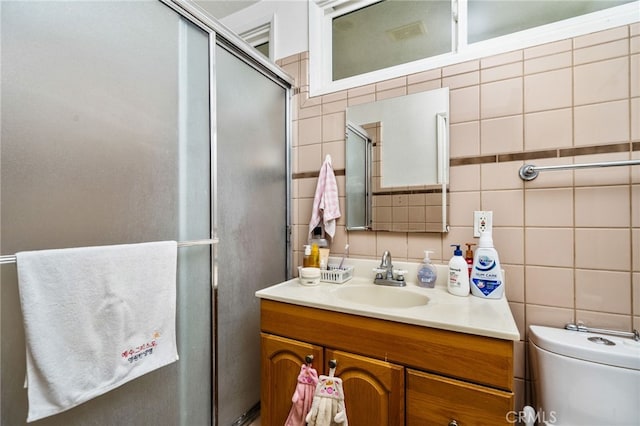 3540 Watkins Dr, Riverside, CA 92507 - bathroom with toilet, vanity, tasteful backsplash, a shower with shower door, and tile walls