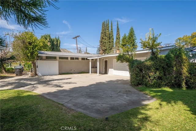 3540 Watkins Dr, Riverside, CA 92507 - view of front of home featuring stucco siding, an attached garage, a front lawn, and driveway
