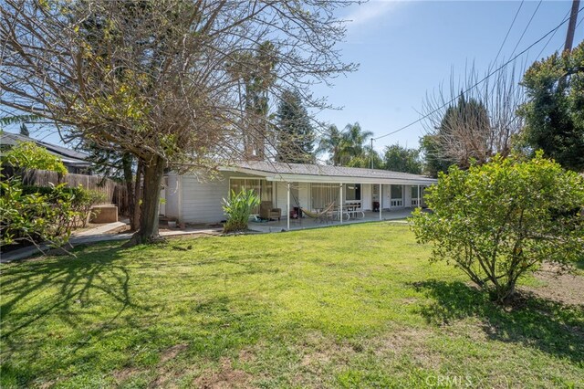 3540 Watkins Dr, Riverside, CA 92507 - rear view of house featuring a lawn, fence, and a patio