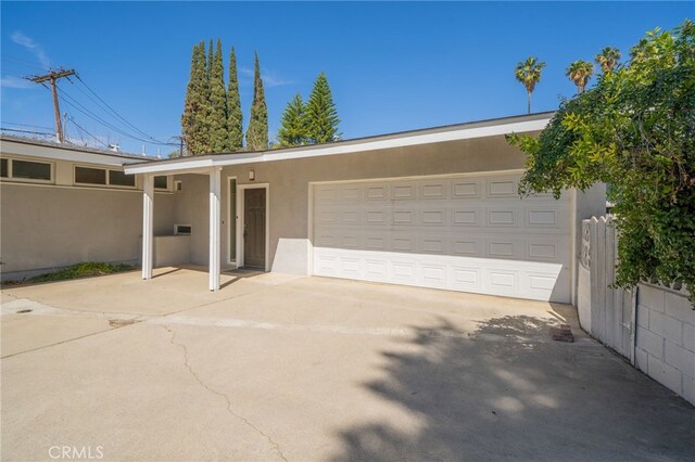 3540 Watkins Dr, Riverside, CA 92507 - view of front of house featuring stucco siding, a garage, concrete driveway, and fence