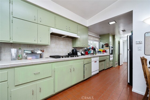 3540 Watkins Dr, Riverside, CA 92507 - kitchen with backsplash, light countertops, stainless steel appliances, and under cabinet range hood
