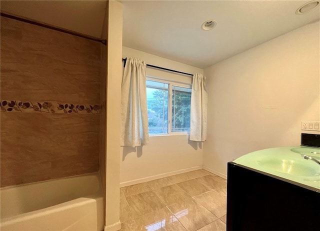 full bathroom with vanity, shower / bathtub combination, and baseboards
