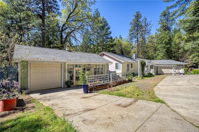 ranch-style home featuring a porch, an attached garage, and driveway