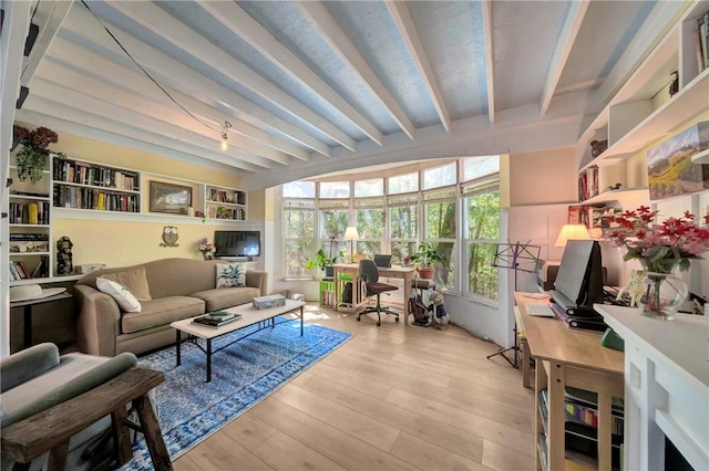 living area with beam ceiling and light wood finished floors