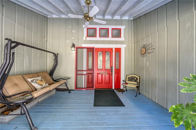 view of exterior entry with ceiling fan